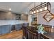 Stylish dining room featuring gray cabinets, a wine cooler, hardwood floors, and access to the living room at 4047 Dunwoody Club Dr, Dunwoody, GA 30350