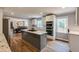 Modern eat-in kitchen with island cooktop, stainless steel appliances, and an open floorplan at 4047 Dunwoody Club Dr, Dunwoody, GA 30350