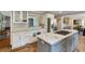Spacious eat-in kitchen boasts an island cooktop, stainless steel appliances, and granite countertops at 4047 Dunwoody Club Dr, Dunwoody, GA 30350