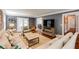 Living room featuring hardwood floors, neutral furniture, crown moulding, and open access to other rooms at 4047 Dunwoody Club Dr, Dunwoody, GA 30350