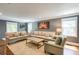 Well-lit living room with neutral furniture, hardwood floors, and a decorative wall hanging at 4047 Dunwoody Club Dr, Dunwoody, GA 30350
