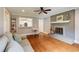 Open floorplan living room featuring a grey painted brick fireplace and a view into the eat-in kitchen at 4047 Dunwoody Club Dr, Dunwoody, GA 30350
