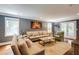Bright living room featuring neutral furniture, wood floors, two windows, and a decorative piece of art at 4047 Dunwoody Club Dr, Dunwoody, GA 30350