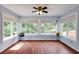 Bright sun room with wood floors, beadboard paneling, and large windows overlooking the yard at 4047 Dunwoody Club Dr, Dunwoody, GA 30350