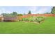 Backyard features a trampoline, a grass lawn, a wooden fence, and multiple gardening areas at 4455 Orchard Lake Dr, Cumming, GA 30028