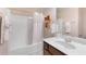 This bathroom is designed with a tub and shower combination, and a well lit vanity area at 4455 Orchard Lake Dr, Cumming, GA 30028