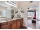 Bathroom showcasing dual sinks, storage vanity, and well-lit mirror at 4455 Orchard Lake Dr, Cumming, GA 30028