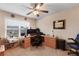 This carpeted room features a ceiling fan, a desk area, and natural light from a window at 4455 Orchard Lake Dr, Cumming, GA 30028