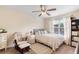 Cozy bedroom with natural light, plush carpeting, ceiling fan, and neutral decor for a restful atmosphere at 4455 Orchard Lake Dr, Cumming, GA 30028