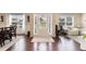 Inviting foyer featuring hardwood floors, a bright front door, and adjacent dining and living spaces at 4455 Orchard Lake Dr, Cumming, GA 30028