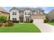Beautiful two-story home boasts brick and siding exterior, well-manicured lawn, and attached two car garage at 4455 Orchard Lake Dr, Cumming, GA 30028
