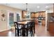 Eat-in kitchen featuring wood cabinetry, stainless steel appliances, breakfast nook and hardwood floors at 4455 Orchard Lake Dr, Cumming, GA 30028
