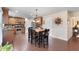 Open-concept kitchen with wood cabinets, stainless appliances, breakfast area, and convenient access to other living areas at 4455 Orchard Lake Dr, Cumming, GA 30028