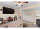 Relaxing open-concept living room featuring carpet, television, and media center at 4455 Orchard Lake Dr, Cumming, GA 30028