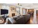 Comfortable living room featuring a fireplace, hardwood floors, and an open layout leading into kitchen at 4455 Orchard Lake Dr, Cumming, GA 30028