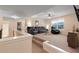 Cozy carpeted living room with black leather seating, ceiling fan, and bright natural light at 4455 Orchard Lake Dr, Cumming, GA 30028