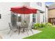 Outdoor patio features an umbrella-covered table with chairs, next to a lush garden area at 4455 Orchard Lake Dr, Cumming, GA 30028
