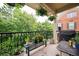 Relaxing balcony features wrought iron railing, ample sunlight, seating, and grill at 827 Perennial Dr, Atlanta, GA 30328