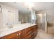 Bright bathroom featuring a double vanity, large mirror, glass shower, and soaking tub at 827 Perennial Dr, Atlanta, GA 30328