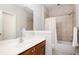 Tiled bathroom features a shower and tub combination and a wood vanity at 827 Perennial Dr, Atlanta, GA 30328