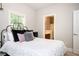 Comfortable bedroom features a closet and door to the bathroom at 827 Perennial Dr, Atlanta, GA 30328
