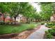 Well-manicured courtyard with mature trees, lush lawn, and walking paths at 827 Perennial Dr, Atlanta, GA 30328