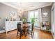 Bright dining area featuring hardwood floors, a unique light fixture, and a large window at 827 Perennial Dr, Atlanta, GA 30328