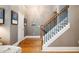 Bright foyer with hardwood floors, staircase with wooden railing, and neutral walls. Art adorns the walls at 827 Perennial Dr, Atlanta, GA 30328