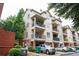 Complex exterior featuring private balconies, attached garages, and mature landscaping at 827 Perennial Dr, Atlanta, GA 30328