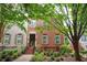 Charming two-story brick home with manicured landscaping and inviting front entrance and neutral shutters at 827 Perennial Dr, Atlanta, GA 30328
