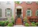 Inviting two-story brick home with manicured front yard and welcoming front porch and neutral shutters at 827 Perennial Dr, Atlanta, GA 30328