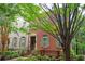 Charming two-story brick home with manicured landscaping and inviting front entrance and neutral shutters at 827 Perennial Dr, Atlanta, GA 30328