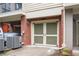 Private attached garage with vintage paneled garage door and brick facade at 827 Perennial Dr, Atlanta, GA 30328