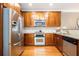 This kitchen has stainless steel appliances, granite countertops, and beautiful wood cabinets at 827 Perennial Dr, Atlanta, GA 30328