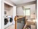 Second floor landing features a laundry closet with a washer and dryer at 827 Perennial Dr, Atlanta, GA 30328