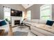 Cozy living room with fireplace, large windows, vaulted ceilings, and comfortable seating arrangement at 827 Perennial Dr, Atlanta, GA 30328
