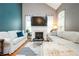 Comfortable living room with fireplace, large windows, vaulted ceilings, and modern decor at 827 Perennial Dr, Atlanta, GA 30328
