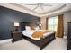 Comfortable main bedroom featuring a tray ceiling, ceiling fan, and ample natural light at 827 Perennial Dr, Atlanta, GA 30328