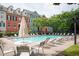Community pool with many chairs and umbrellas, surrounded by beautiful multi-story townhomes at 827 Perennial Dr, Atlanta, GA 30328
