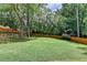 Expansive backyard features lush green grass, mature trees, and a wooden fence at 1169 Dorby Park Ne Dr, Brookhaven, GA 30319