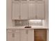 Wet bar area with white cabinets, stone countertop, and a beverage refrigerator at 1169 Dorby Park Ne Dr, Brookhaven, GA 30319