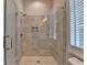 Bathroom features a glass shower with tile surround, niche, and a shuttered window at 1169 Dorby Park Ne Dr, Brookhaven, GA 30319