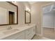 Bathroom featuring dual sinks with white cabinets and framed mirrors at 1169 Dorby Park Ne Dr, Brookhaven, GA 30319