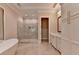 Bright bathroom featuring a glass shower, soaking tub, custom cabinets, and modern fixtures at 1169 Dorby Park Ne Dr, Brookhaven, GA 30319