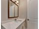 Bathroom features white vanity with gold hardware, white quartz countertop, and a framed mirror at 1169 Dorby Park Ne Dr, Brookhaven, GA 30319
