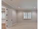 Bedroom with neutral carpeting, panelled walls, and windows with white shutters at 1169 Dorby Park Ne Dr, Brookhaven, GA 30319