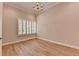 Bright bedroom boasts hardwood floors, a chandelier, neutral walls, and shuttered windows at 1169 Dorby Park Ne Dr, Brookhaven, GA 30319