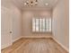 Bright bedroom boasts hardwood floors, a chandelier, neutral walls, and shuttered windows at 1169 Dorby Park Ne Dr, Brookhaven, GA 30319
