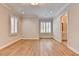 Bright bedroom with hardwood floors, plantation shutters, and a view of a bathroom at 1169 Dorby Park Ne Dr, Brookhaven, GA 30319