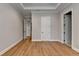 Spacious bedroom featuring hardwood floors, tray ceiling, and a view of multiple doorways at 1169 Dorby Park Ne Dr, Brookhaven, GA 30319